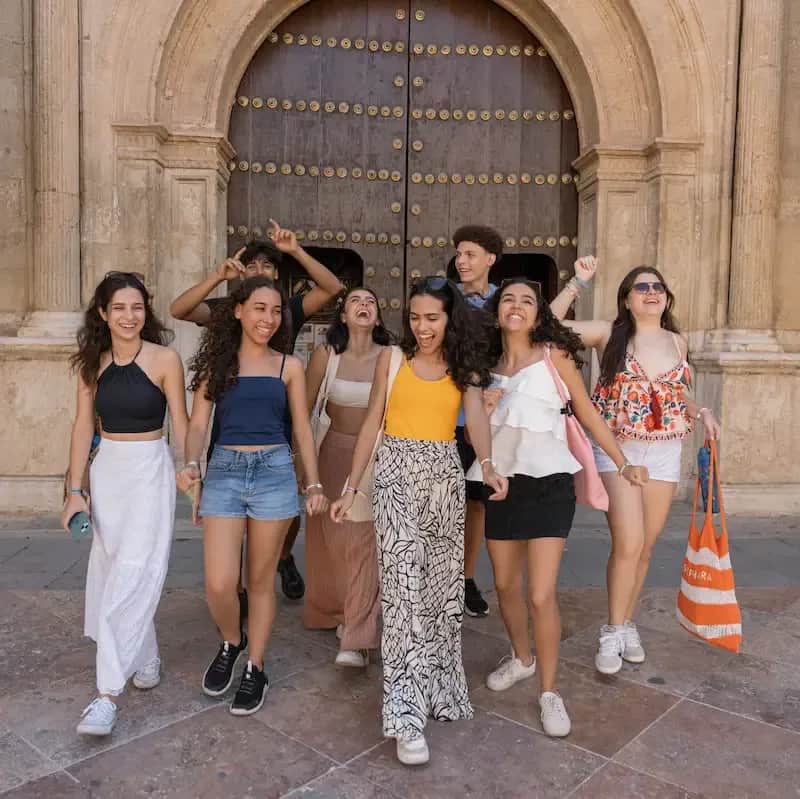 Expanish summer camp students enjoying a city activity while walking together in a historic city center